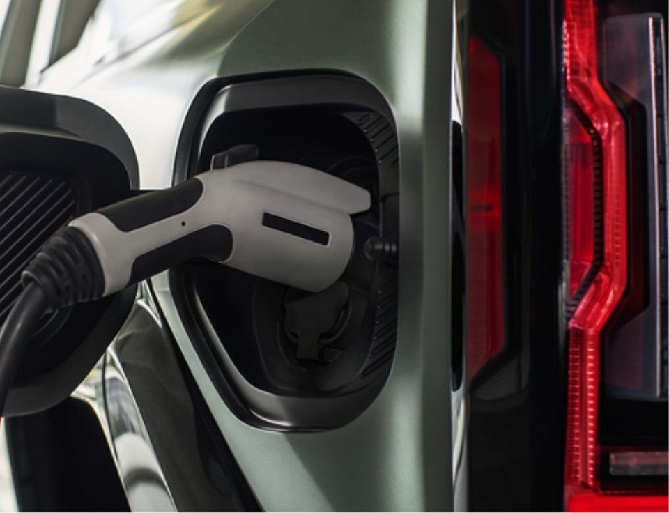 Close up of charging port with charger plugged in on a GMC Hummer EV SUV - Dunn Country GMC in EUFAULA OK